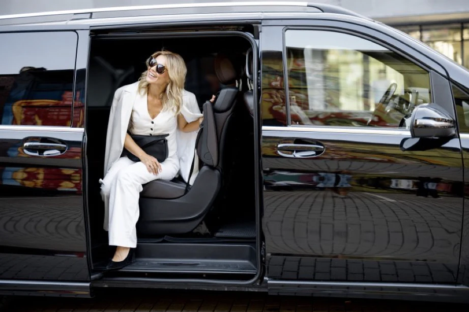 A guest seated in a private chauffeur vehicle